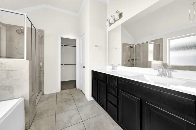 a bathroom with a bathtub and a shower