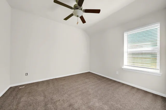 a bathroom with a sink a toilet a light fixture and a window