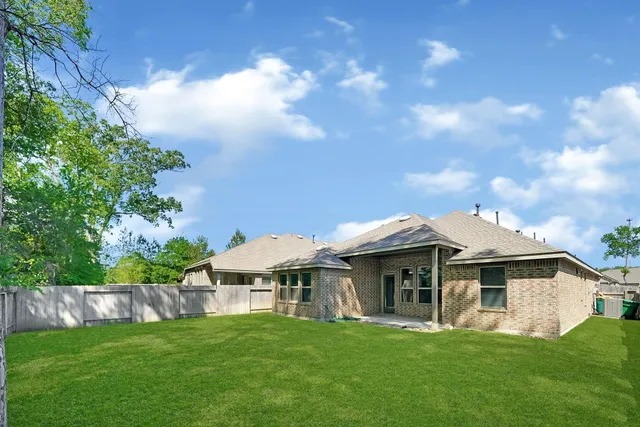 a front view of a house with a garden and plants