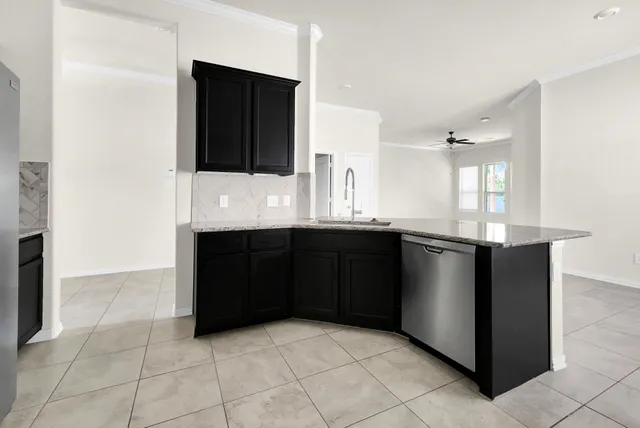 a kitchen with a sink and a refrigerator