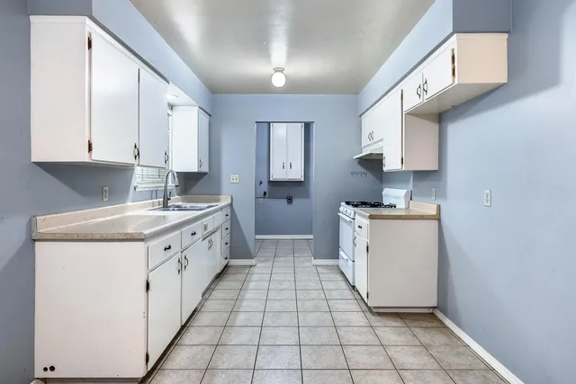 a view of storage and utility room with cabinet