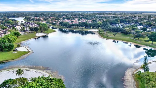 an aerial view of residential houses with outdoor space and river