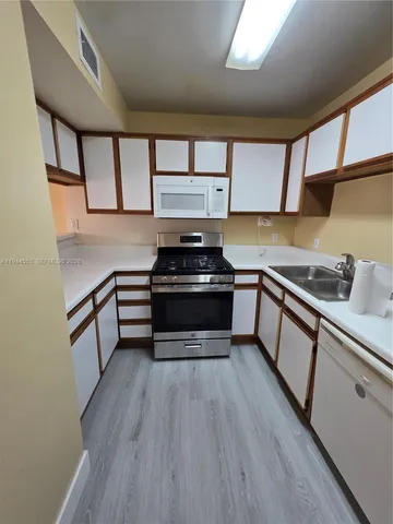 a kitchen with wooden floors and a stove