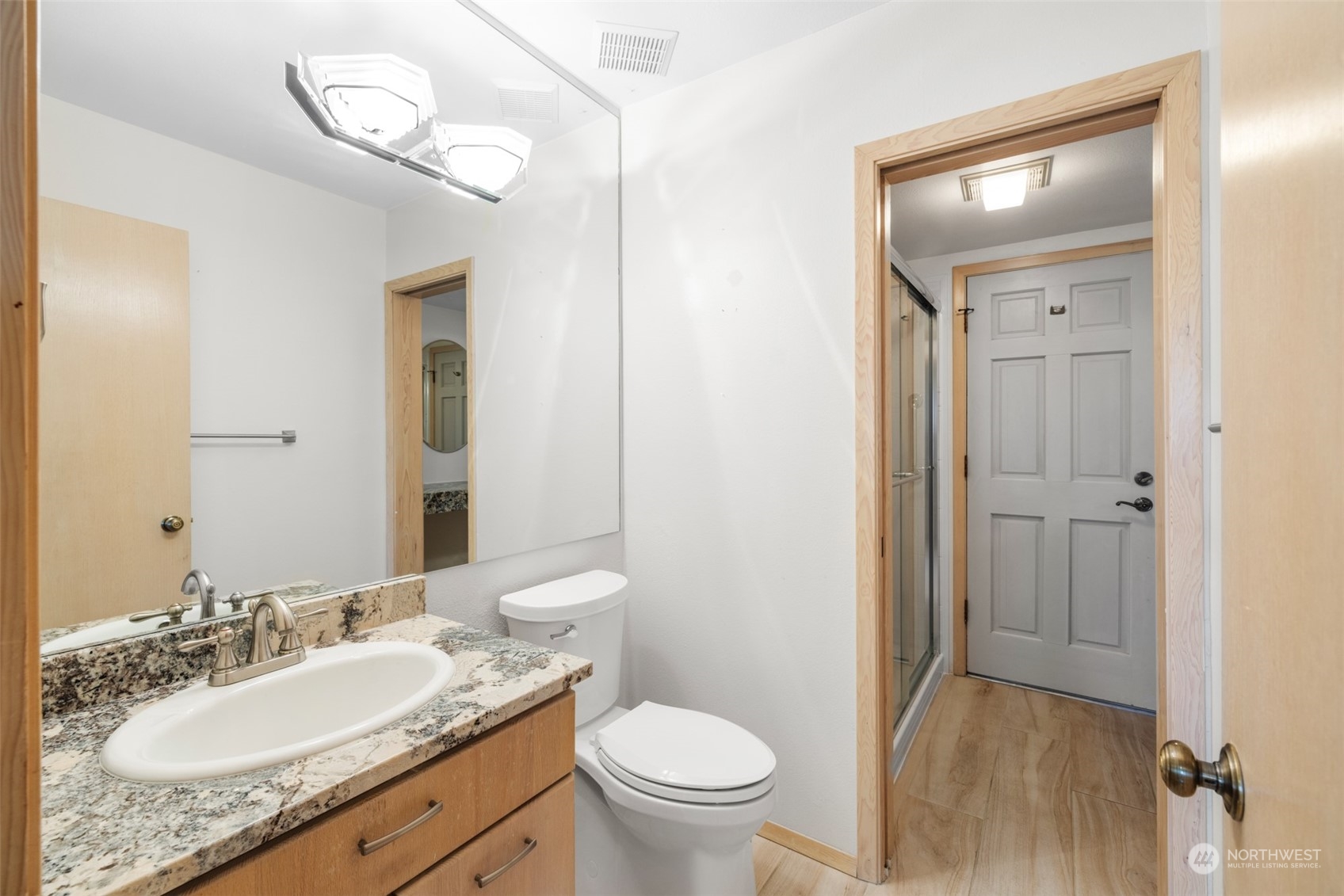 117 Williams Place Sequim, WA 98382 - Photo 18 of 40 a bathroom with a granite countertop sink a toilet and a mirror