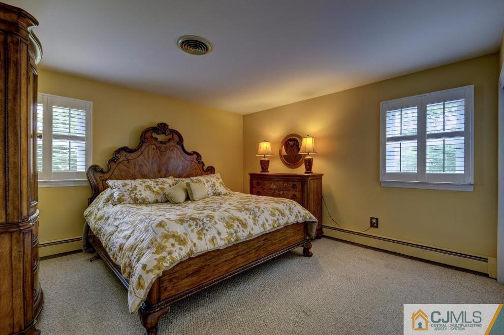 830 Inman Avenue Edison, NJ 08820 - Photo 11 of 21 a bed sitting in a bedroom next to a window