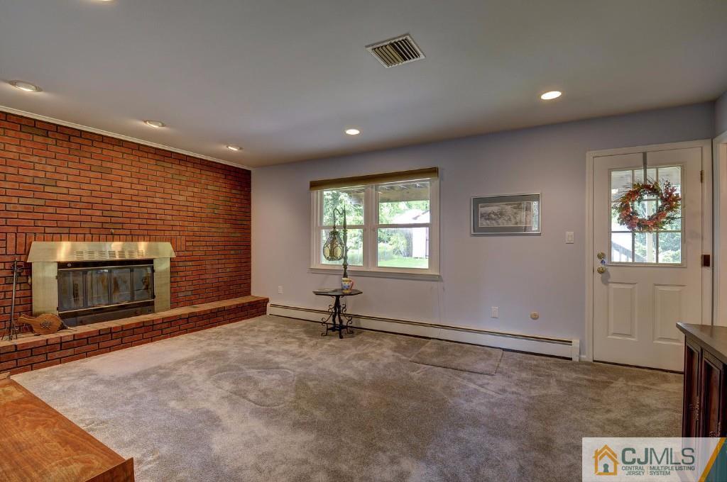 830 Inman Avenue Edison, NJ 08820 - Photo 12 of 21 an empty room with windows and fireplace