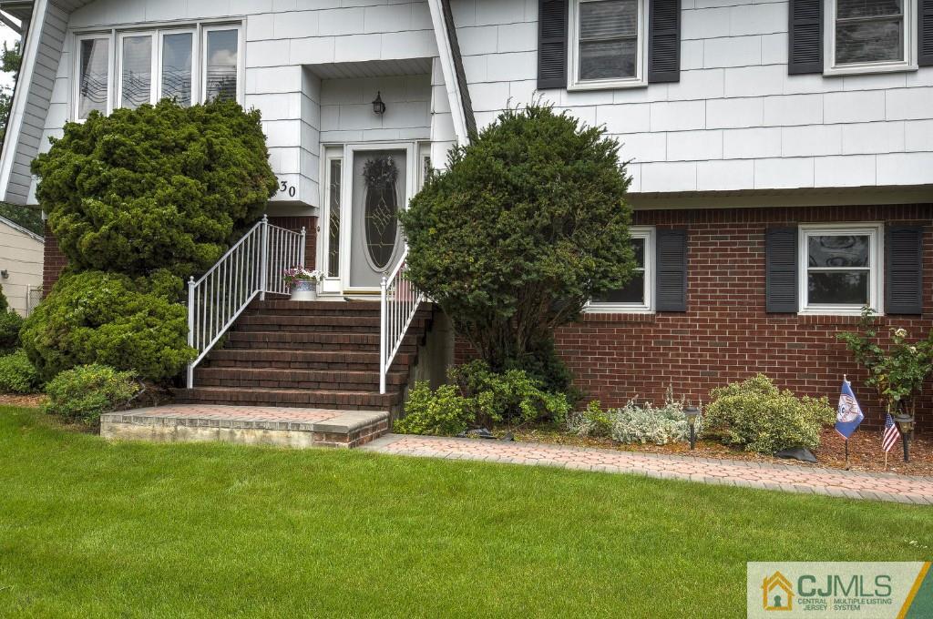 830 Inman Avenue Edison, NJ 08820 - Photo 18 of 21 a view of a house with brick walls and a yard with plants