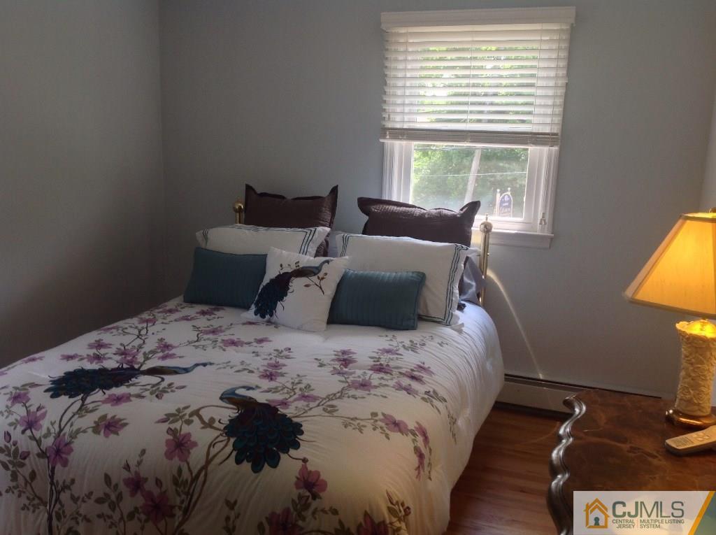 830 Inman Avenue Edison, NJ 08820 - Photo 21 of 21 a bed sitting in a bedroom next to a window