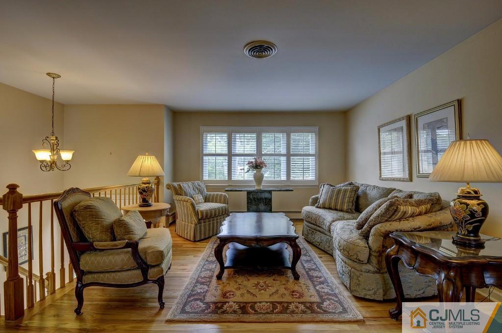 830 Inman Avenue Edison, NJ 08820 - Photo 5 of 21 a living room with furniture a lamp a rug and a window
