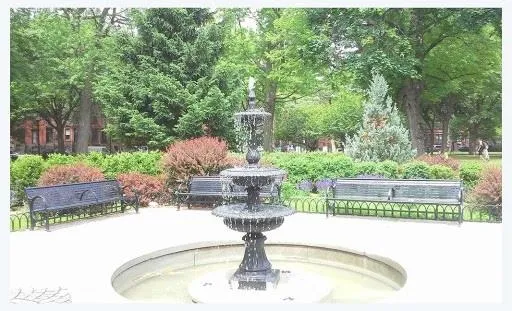 a vase of flowers sitting on a table with a garden