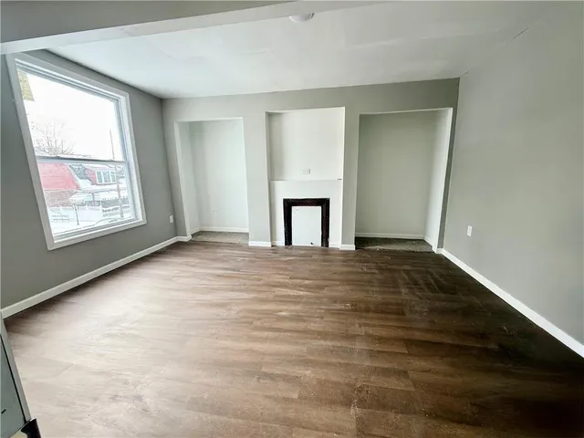 an empty room with windows and closet
