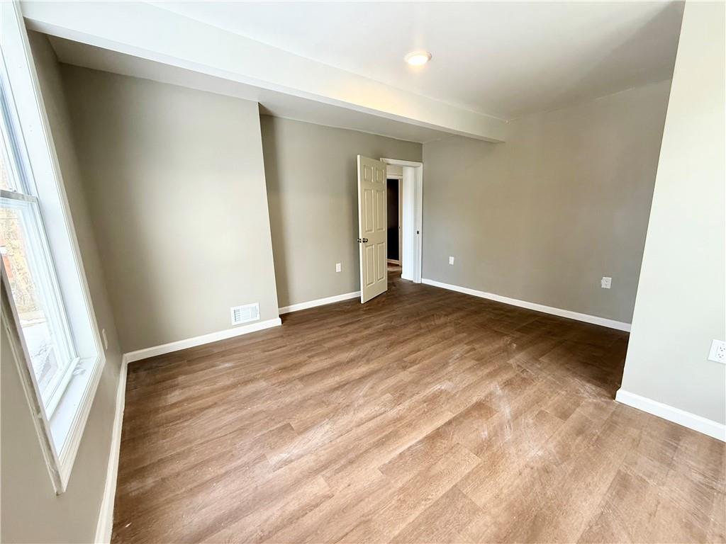 841 2nd Avenue Beaver Falls, PA 15010 - Photo 15 of 23 an empty room with wooden floor and windows