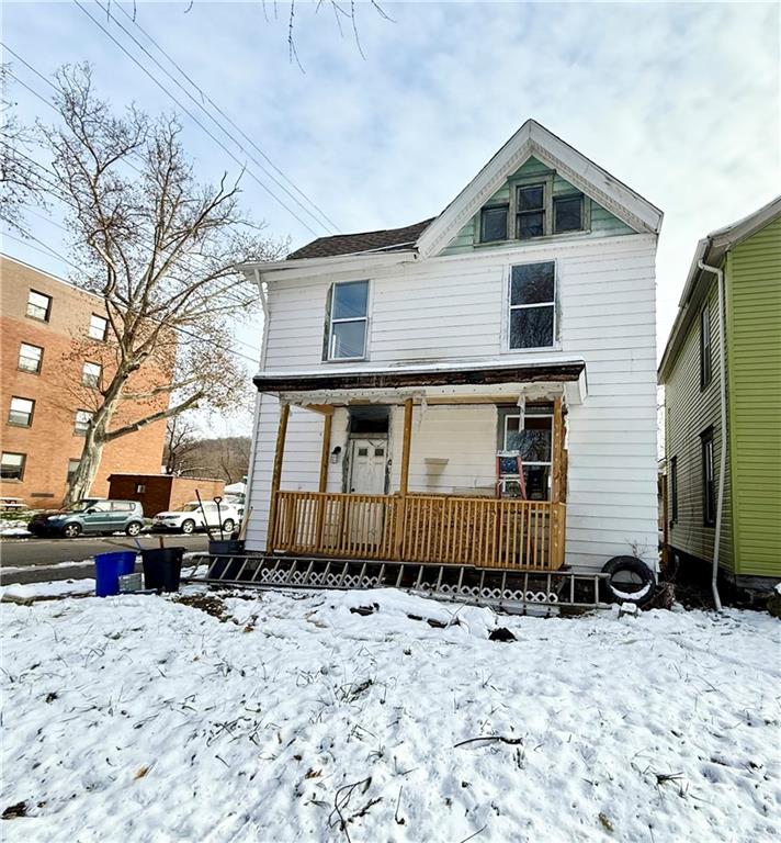841 2nd Avenue Beaver Falls, PA 15010 - Photo 2 of 23 a front view of a house with a yard covered in snow