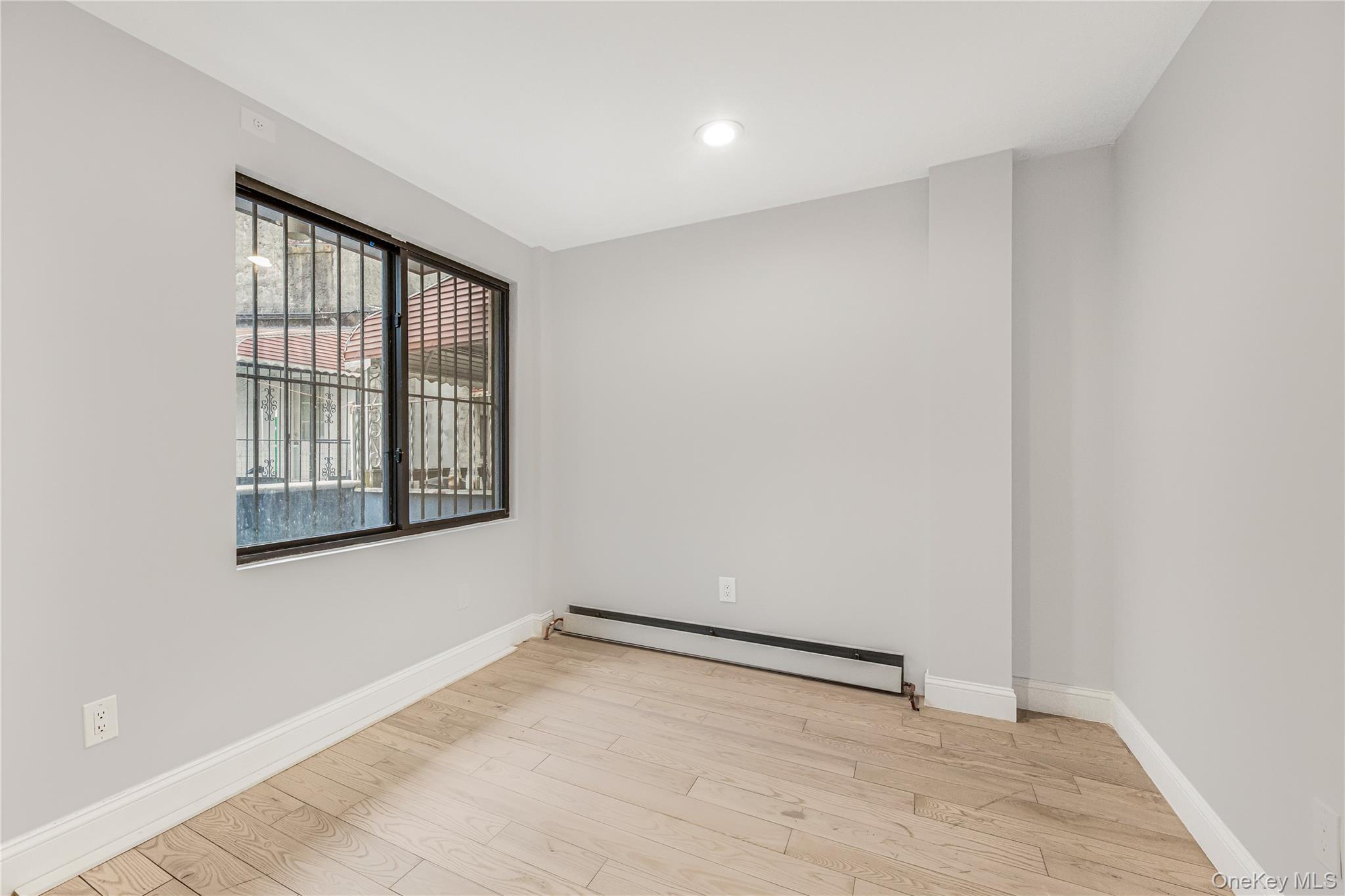 3067 Williamsbridge Road Bronx, NY 10467 - Photo 21 of 29 wooden floor in an empty room with a window