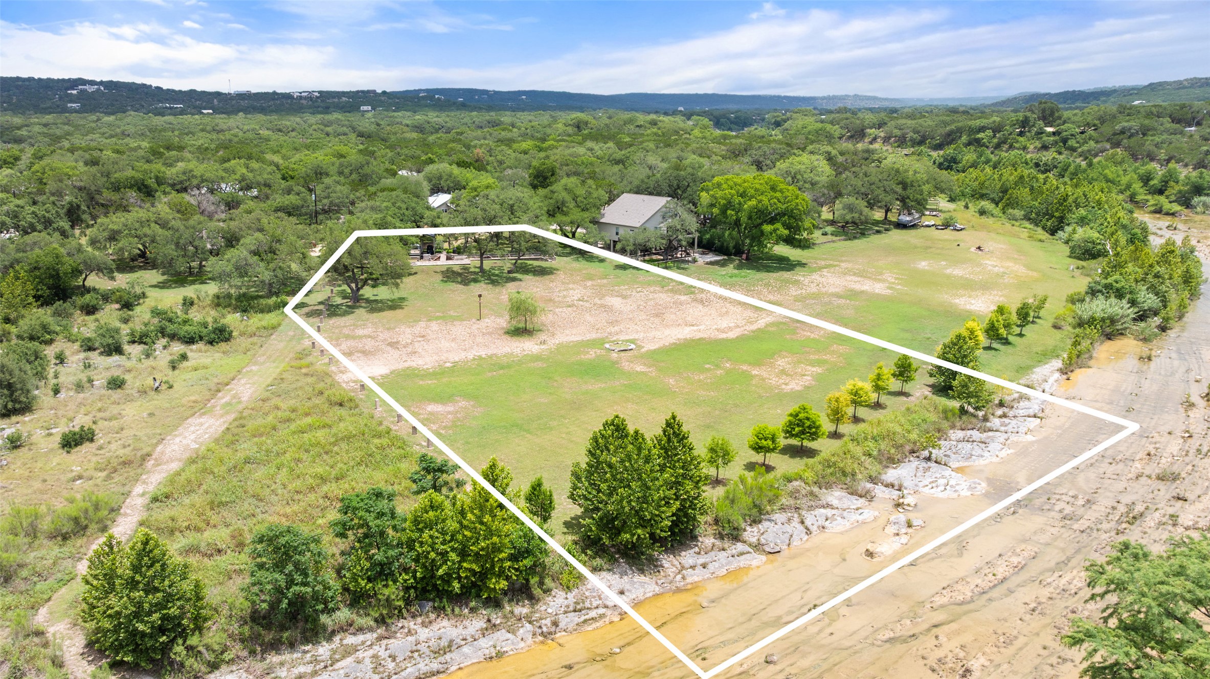 Aerial view of property's location featuring property boundaries highlighted and a forest