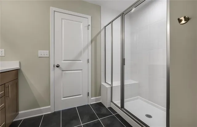 a bathroom with a glass shower door