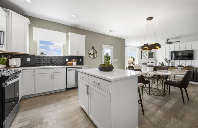 a kitchen with a sink stove and white cabinets