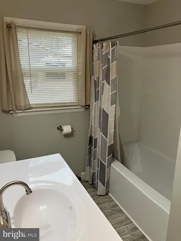 a bathroom with a sink a mirror and a bathtub