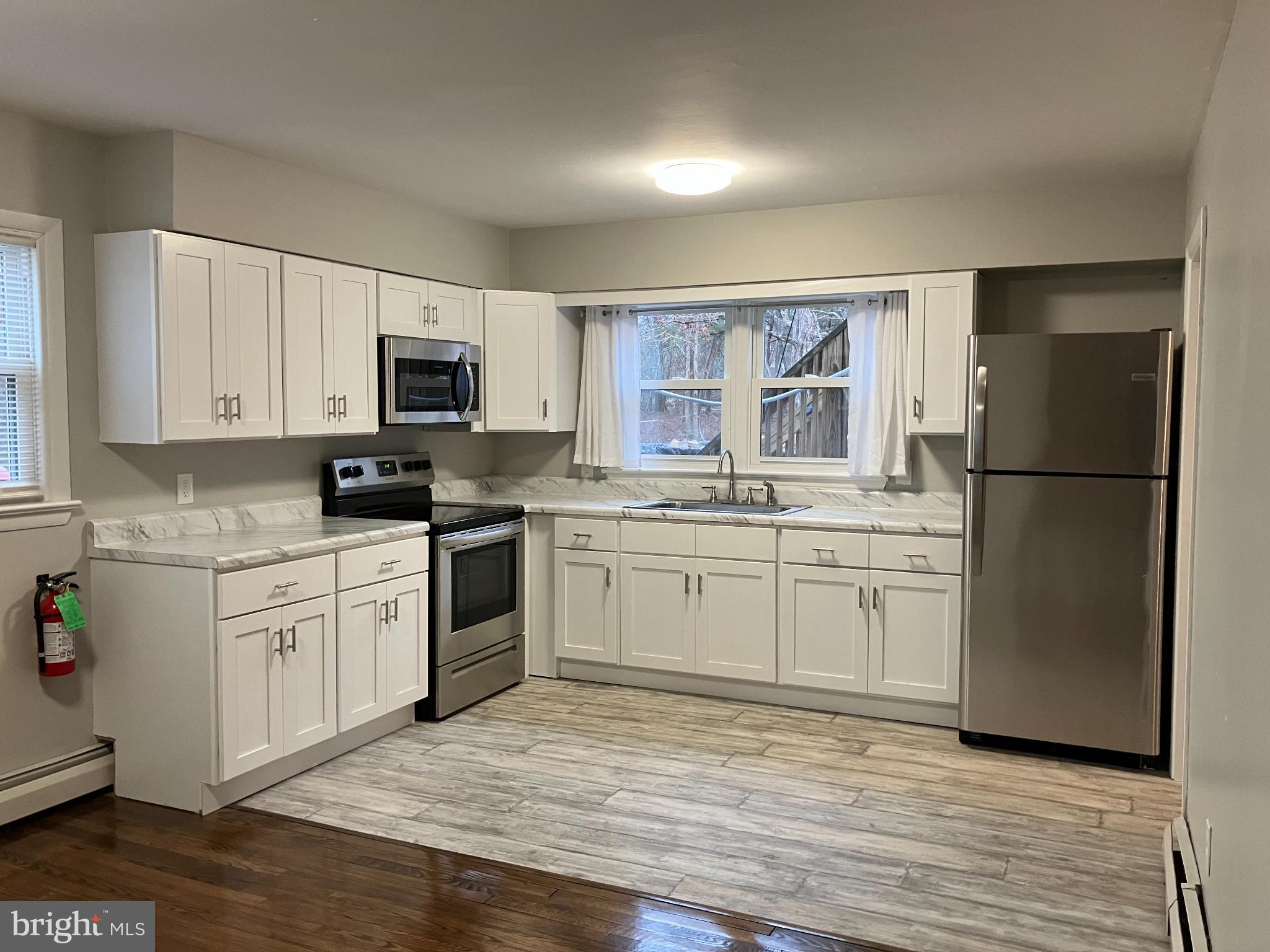 1533 Highway 206 Tabernacle, NJ 08088 - Photo 7 of 14 a kitchen with a refrigerator stove and microwave