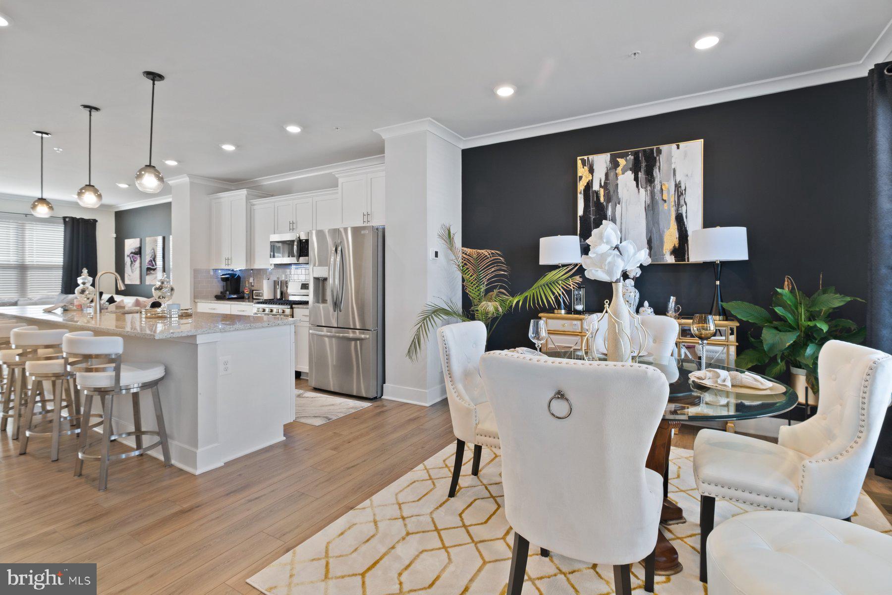 6960 Farragut Drive Bryans Road, MD 20616 - Photo 11 of 25 a kitchen with kitchen island a appliances dining table and chairs