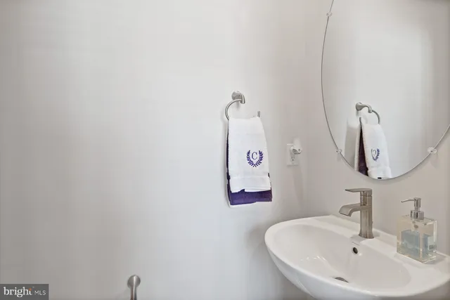 a bathroom with a sink and mirror