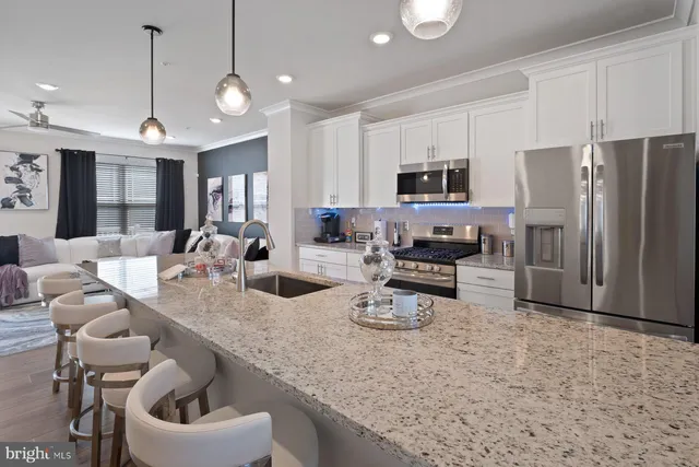 a kitchen with sink refrigerator and microwave