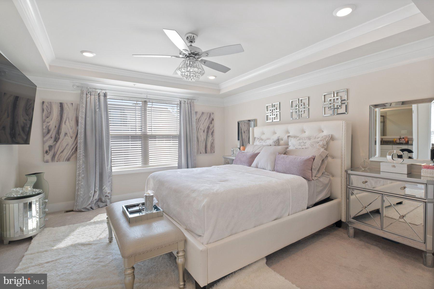 6960 Farragut Drive Bryans Road, MD 20616 - Photo 14 of 25 a bedroom with a large bed and a chandelier