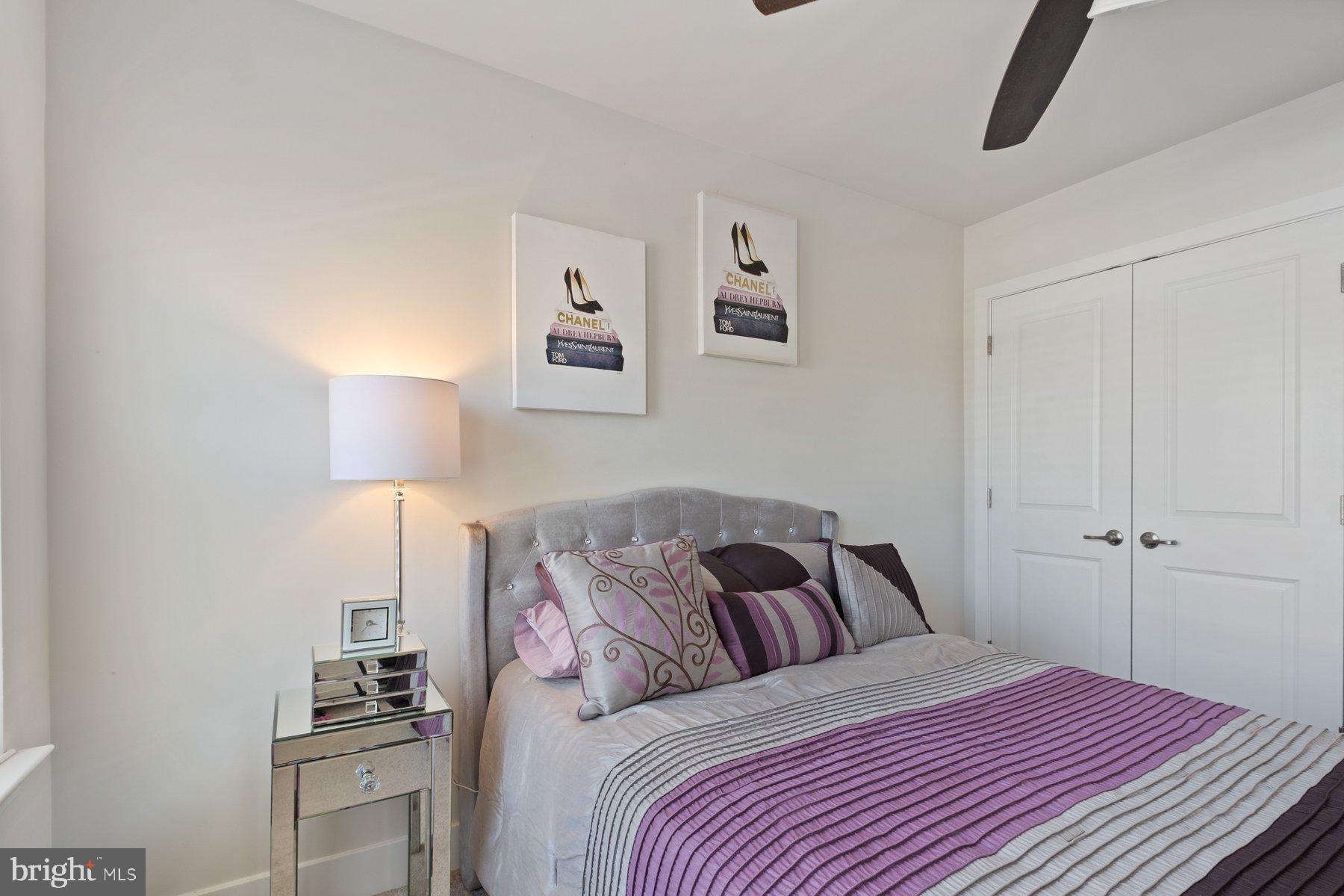 6960 Farragut Drive Bryans Road, MD 20616 - Photo 23 of 25 a bedroom with a bed and a lamp on the dresser