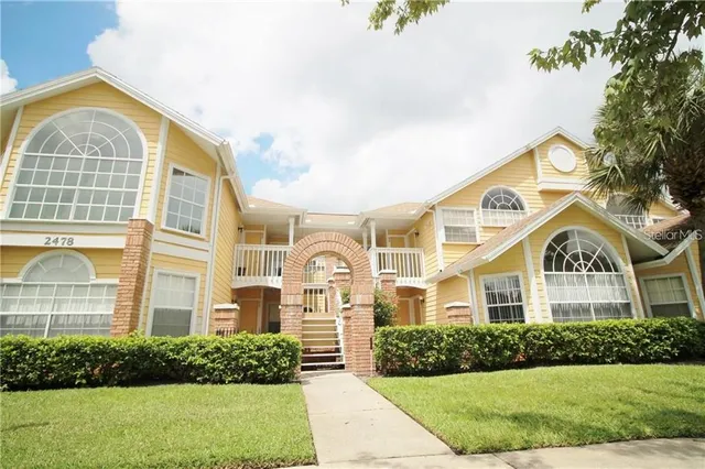 a front view of a residential houses with yard