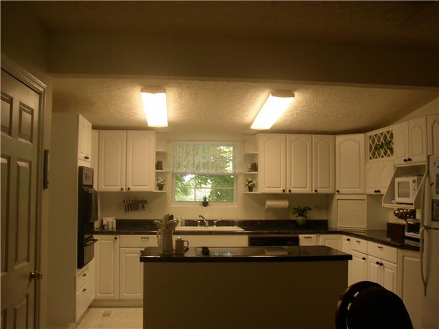 66 Young Mountain Road Pelham, TN 37366 - Photo 11 of 20 a kitchen with stainless steel appliances a sink a stove a refrigerator cabinets and a counter top space