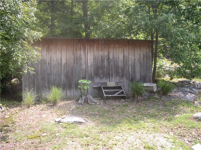 66 Young Mountain Road Pelham, TN 37366 - Photo 7 of 20 a view of a backyard with chairs potted plants and wooden fence