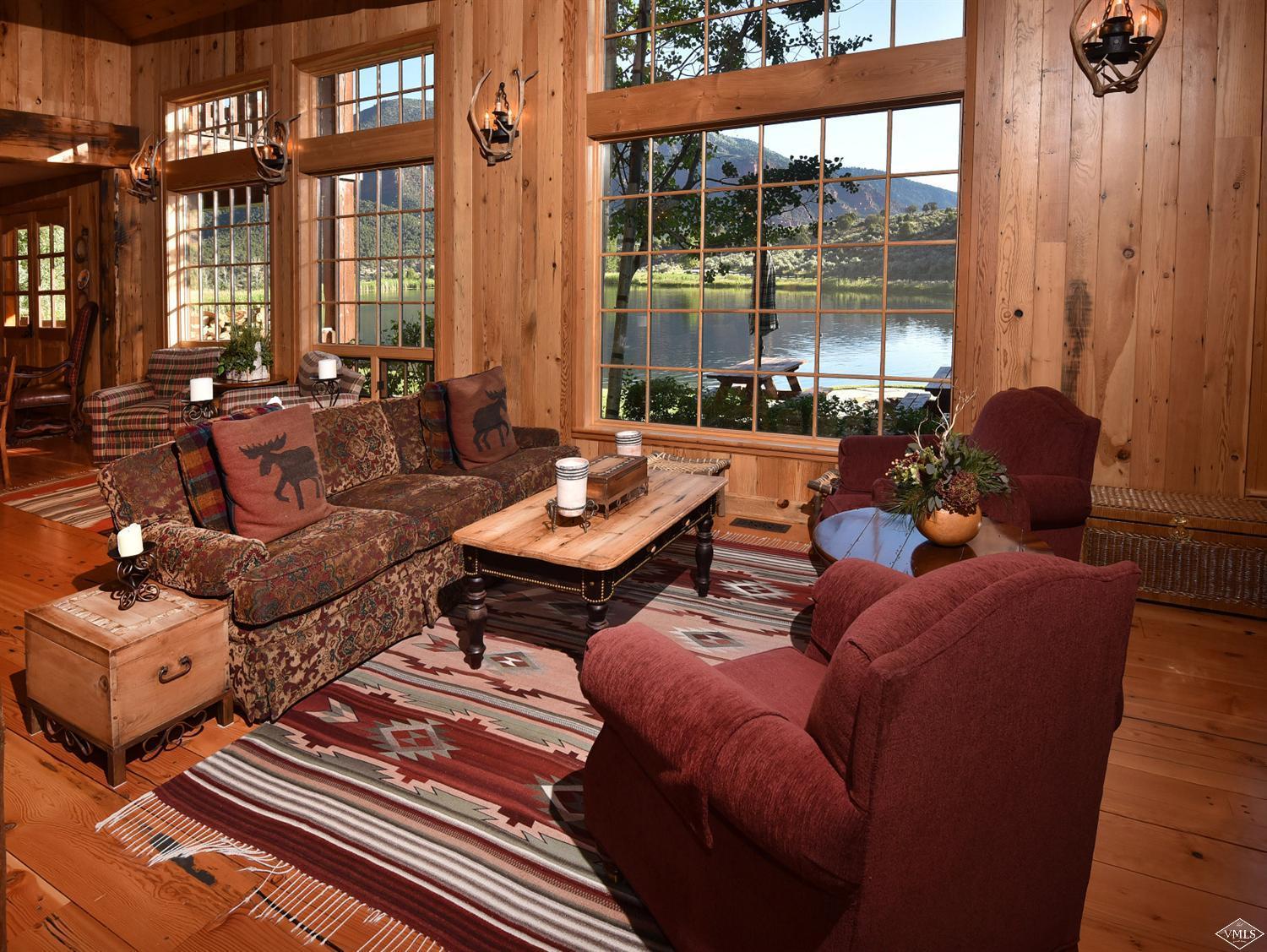 1550 Diamond Star Road Wolcott, CO 81655 - Photo 17 of 25 a living room with furniture and a floor to ceiling window