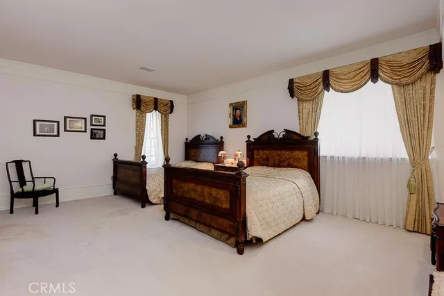 a bed room with a bed and a chair