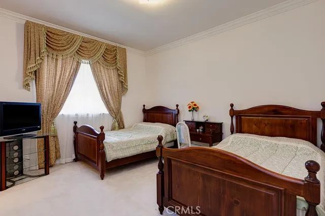 a bedroom with furniture and a flat screen tv