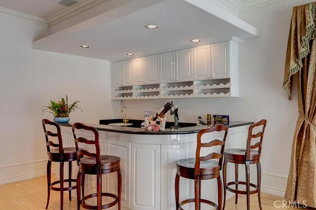 a view of a dining room with furniture and kitchen view