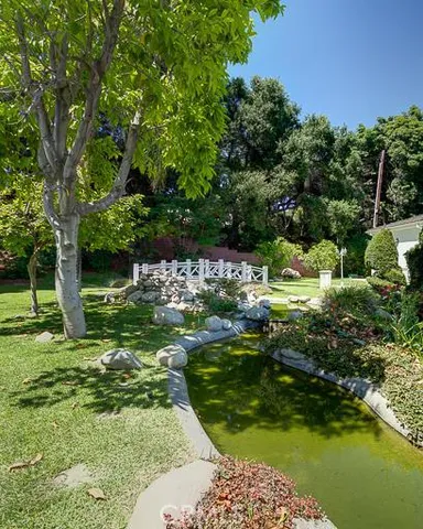 a backyard of a house with a large tree