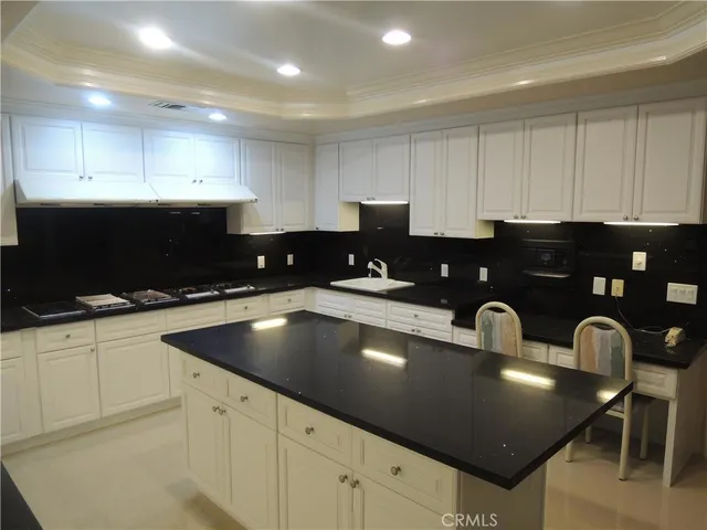 a view of kitchen with refrigerator and wooden floor
