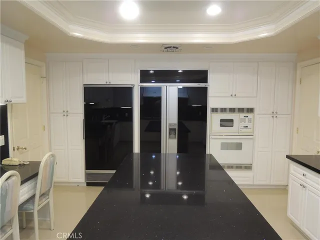 a kitchen with a sink a microwave and cabinets