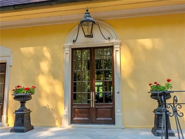 a living room with furniture a rug a fireplace and windows