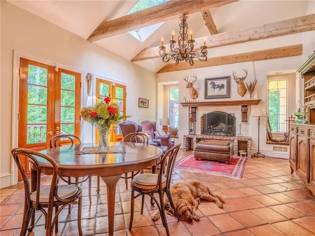 a view of a dining room with furniture a chandelier and wooden floor