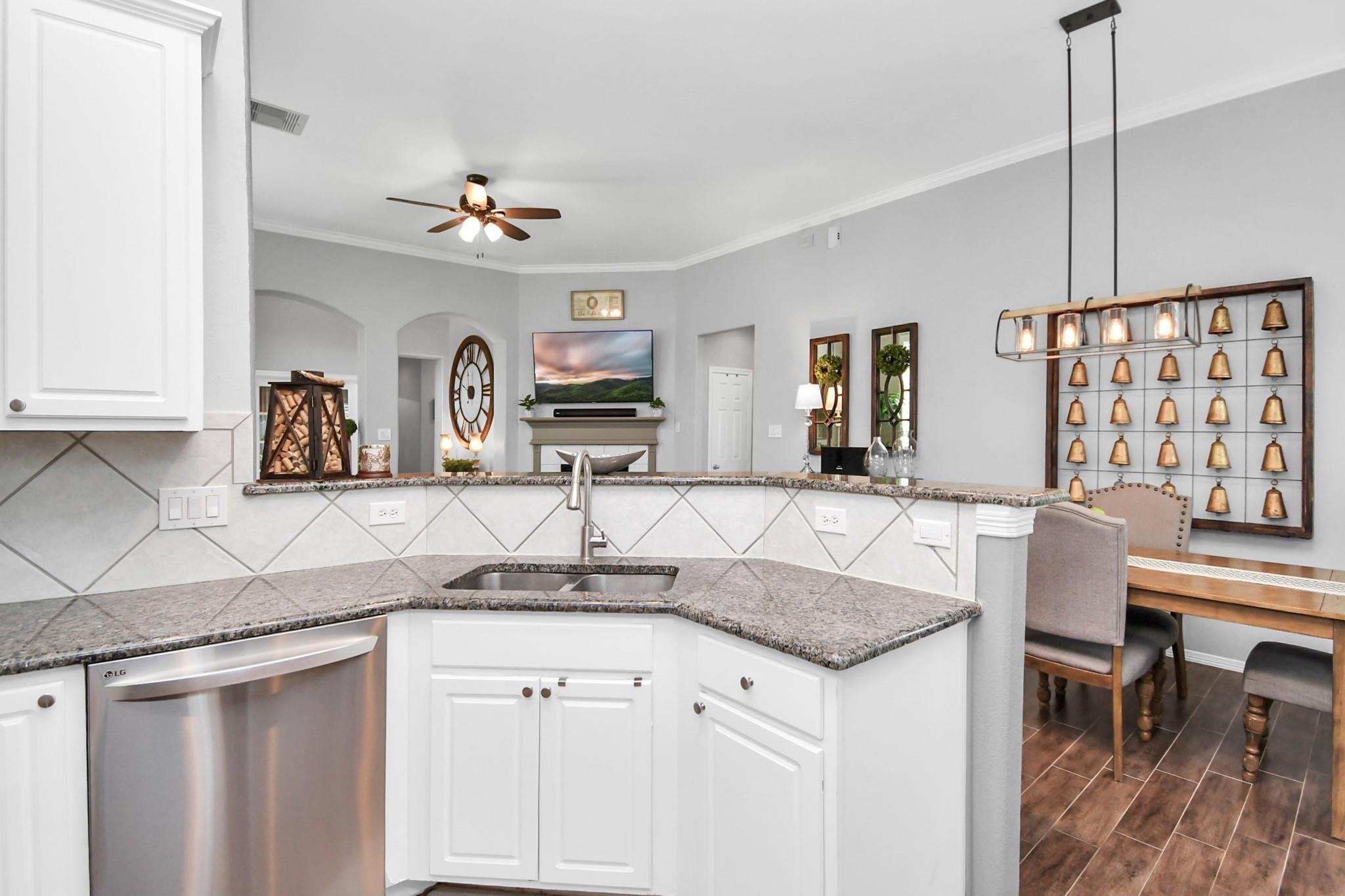 8624 Sunset Loch Drive Spring, TX 77379 - Photo 11 of 44 a kitchen with granite countertop a sink cabinets and window