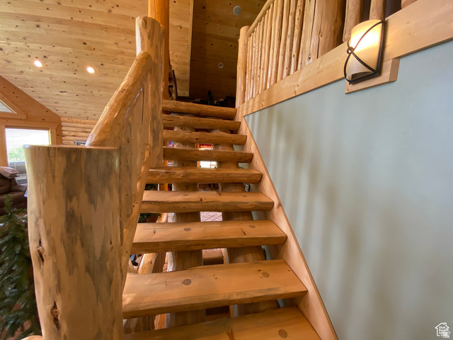 79 Auburn Forest Road Auburn, WY 83111 - Photo 41 of 76 Stairs featuring wooden ceiling, recessed lighting, and rustic walls