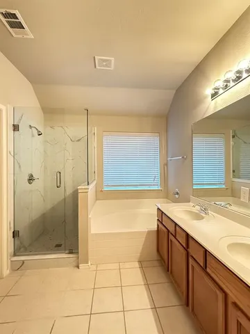 a bathroom with a granite countertop sink a toilet and shower