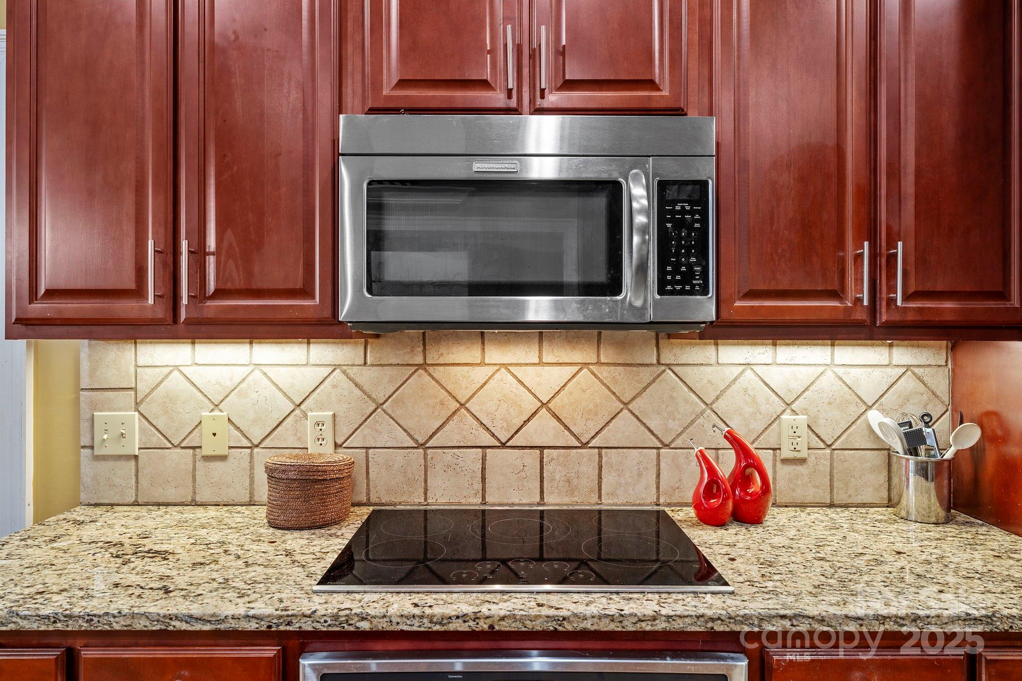 458 Blue Mist Way Arden, NC 28704 - Photo 14 of 47 a kitchen with granite countertop wooden cabinets and a stove top oven