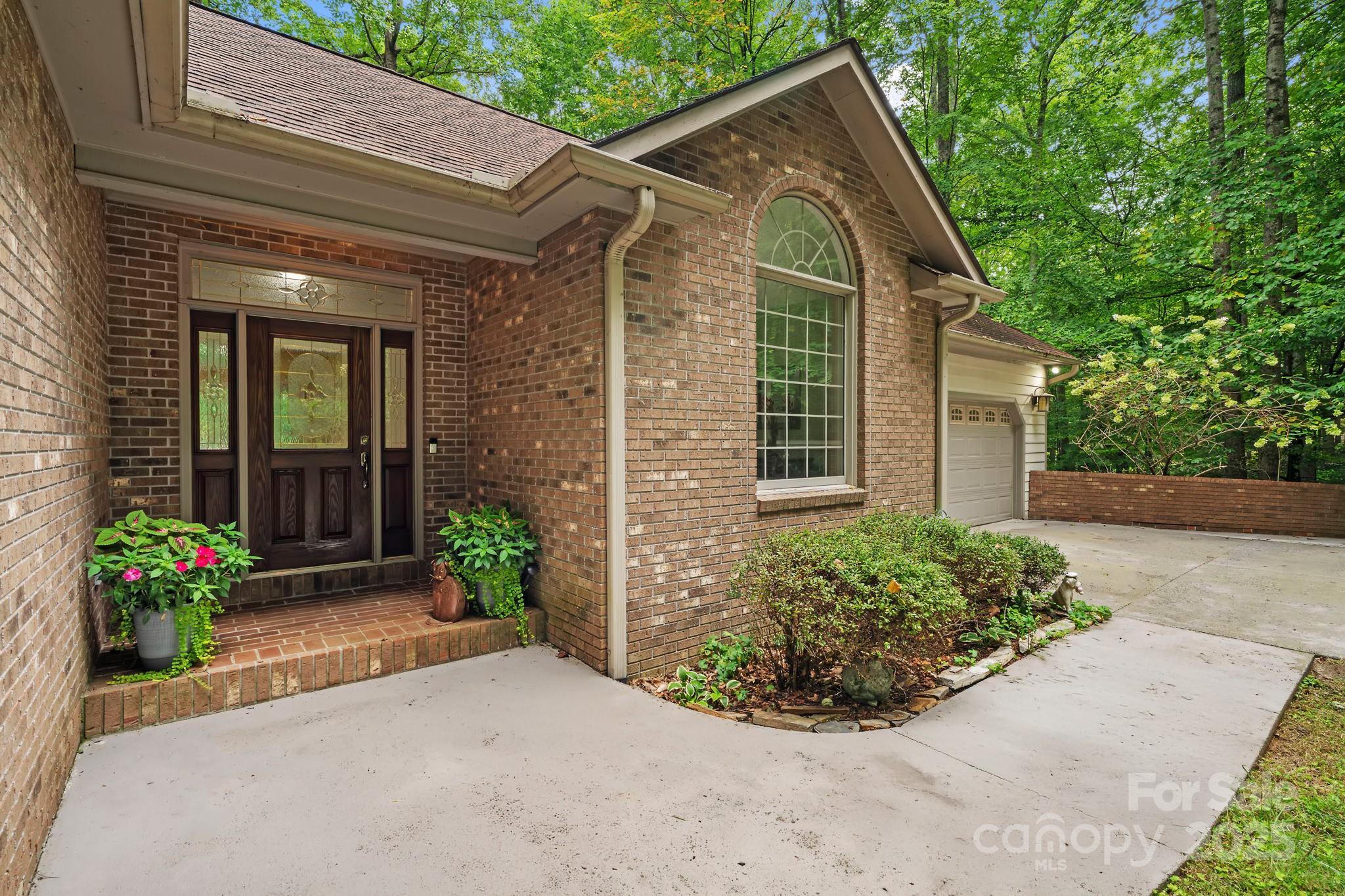 458 Blue Mist Way Arden, NC 28704 - Photo 3 of 47 a front view of a house with garden