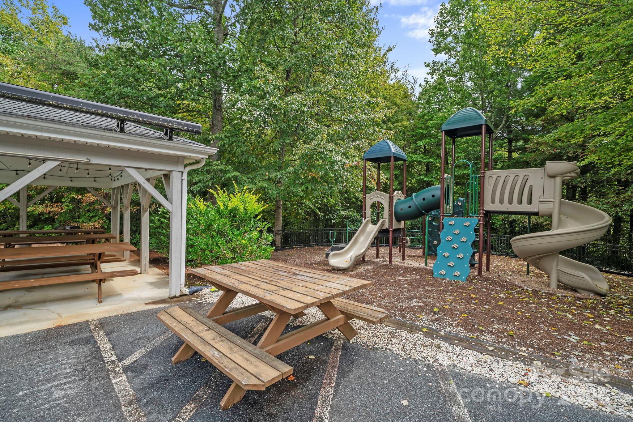 458 Blue Mist Way Arden, NC 28704 - Photo 46 of 47 a view of a patio with table and chairs with wooden floor and fence