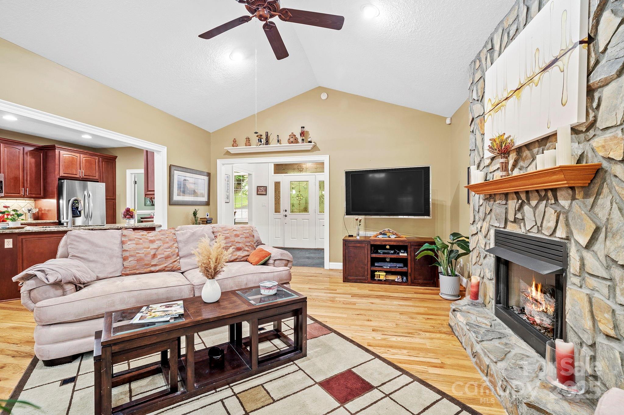 458 Blue Mist Way Arden, NC 28704 - Photo 8 of 47 a living room with furniture a flat screen tv and a fireplace