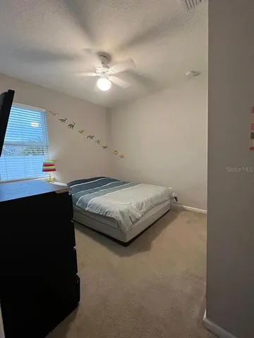 a bedroom with a bed and a lamp