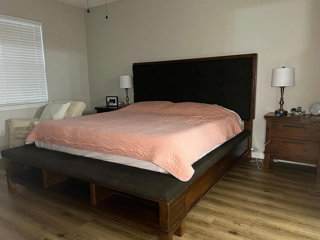 11 Long Point Way St. Augustine, FL 32092 - Photo 9 of 15 a bedroom with a bed and a lamp