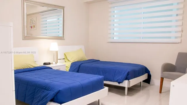 a bedroom with bed and a window